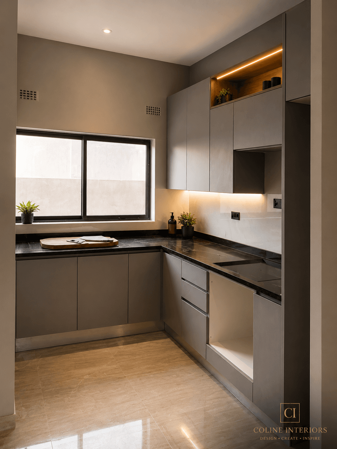 Modern fitted kitchen with handleless cabinetry and stone worktop by Coline Interiors, Lusaka